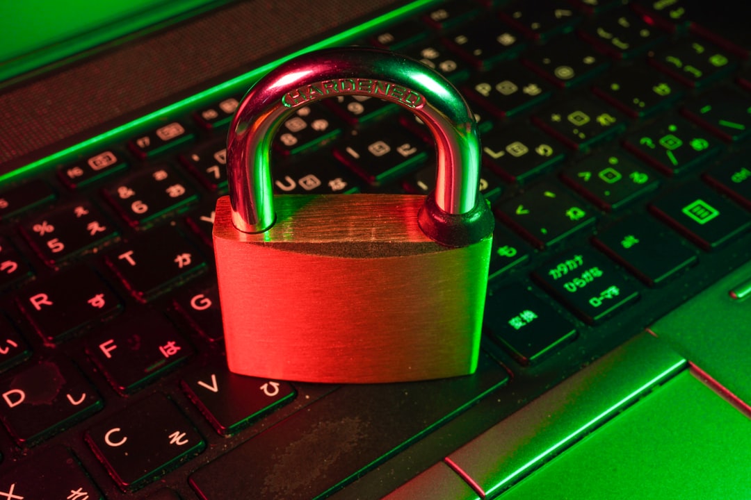 Person protecting laptop from online scams and cyber fraud with security shield