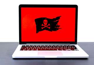 Computer screen displaying security warning about fake website detection and online safety